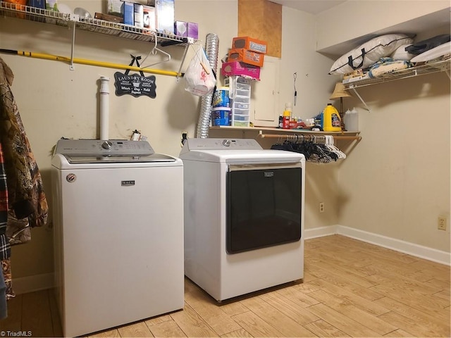 laundry area with independent washer and dryer and light wood-type flooring