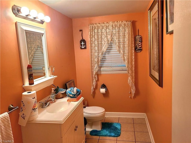 bathroom featuring tile patterned flooring, vanity, and toilet