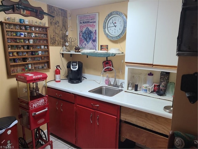 kitchen featuring light tile patterned flooring and sink