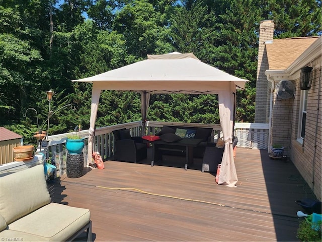 wooden terrace with a gazebo and outdoor lounge area