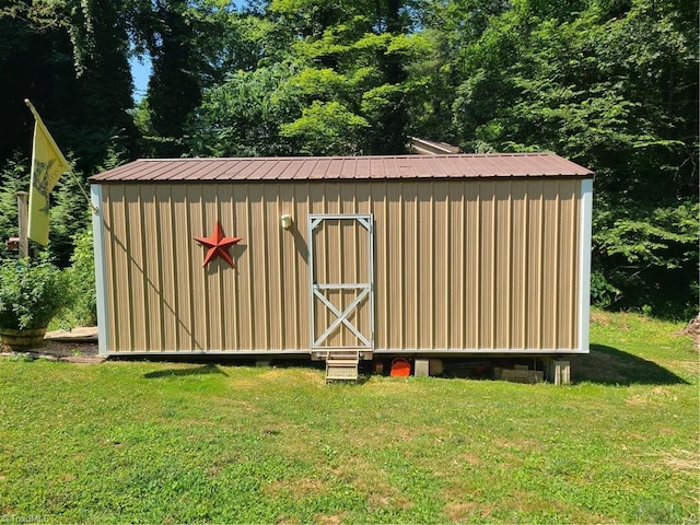 view of outbuilding with a yard