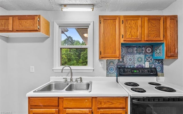1655 Oakleigh Rd, Mcleansville, NC 27301 - kitchen featuring white range with electric cooktop, light countertops, brown cabinetry, and a textured ceiling