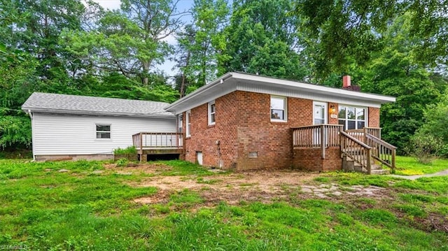 1655 Oakleigh Rd, Mcleansville, NC 27301 - rear view of property with a chimney, crawl space, brick siding, a wooden deck, and view of wooded area