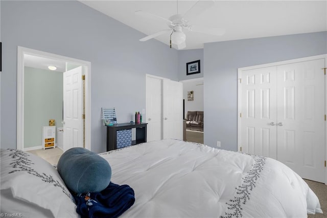 carpeted bedroom featuring ceiling fan, a closet, and vaulted ceiling