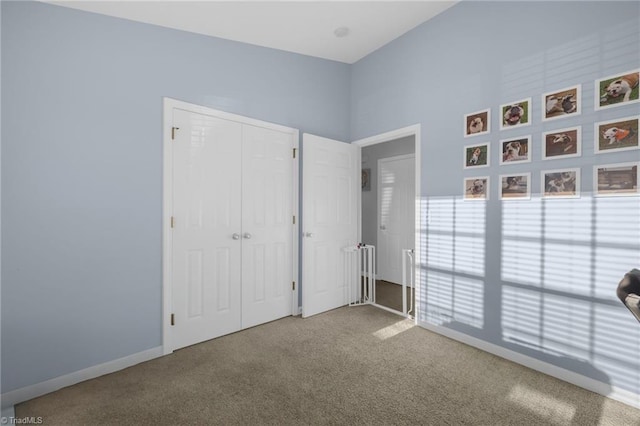 unfurnished bedroom with carpet and a closet