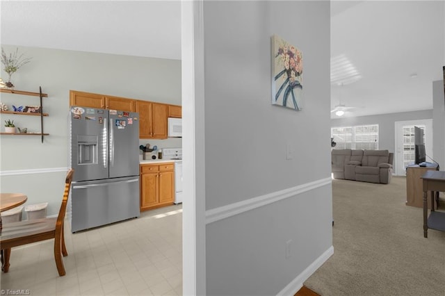 kitchen with light carpet, white appliances, ceiling fan, and lofted ceiling