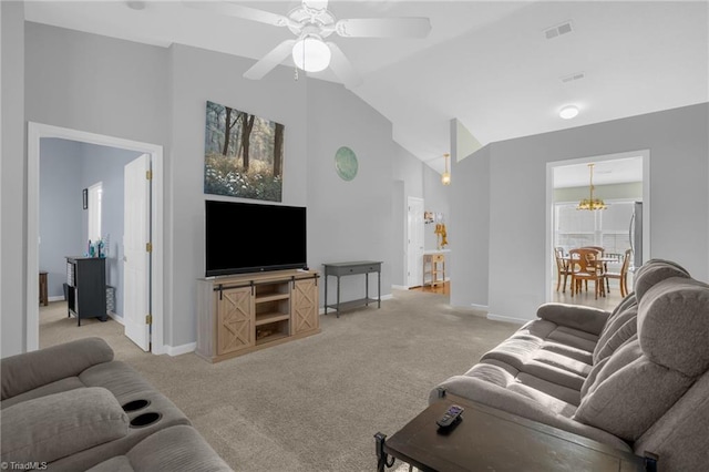 living room featuring vaulted ceiling, light carpet, and ceiling fan with notable chandelier