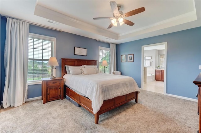 113 Crestbourne Ct, Stokesdale, NC 27357 - bedroom featuring a tray ceiling, crown molding, light colored carpet, connected bathroom, and a ceiling fan