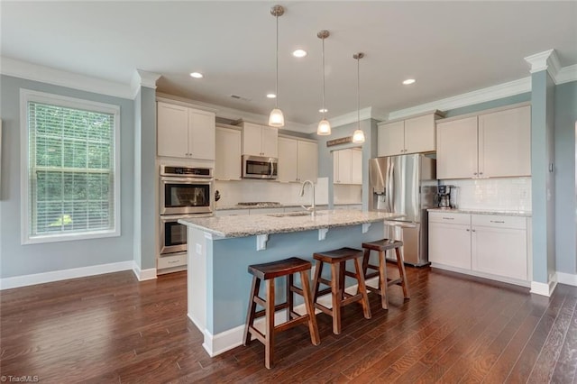 113 Crestbourne Ct, Stokesdale, NC 27357 - kitchen featuring appliances with stainless steel finishes, ornamental molding, tasteful backsplash, a center island with sink, and dark wood-style floors