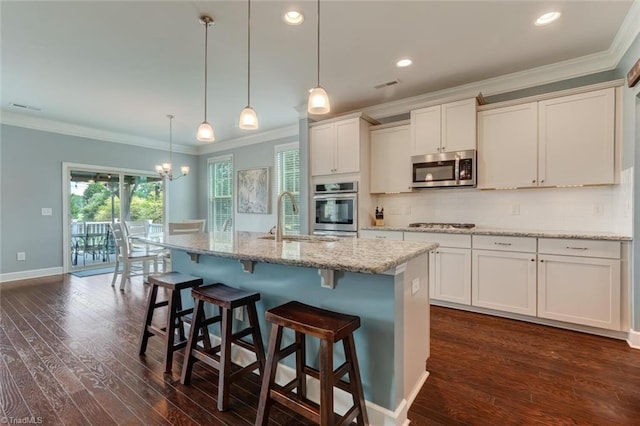 113 Crestbourne Ct, Stokesdale, NC 27357 - kitchen featuring appliances with stainless steel finishes, crown molding, dark wood-style floors, tasteful backsplash, and hanging light fixtures