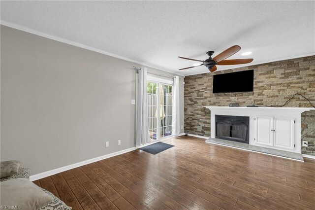 5660 W Market St Unit A, Greensboro, NC 27409 - unfurnished living room with ceiling fan, a textured ceiling, a fireplace, wood finished floors, and ornamental molding