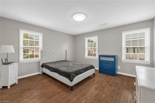 5660 W Market St Unit A, Greensboro, NC 27409 - bedroom featuring baseboards and dark wood-style flooring