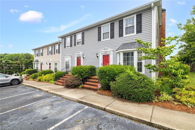 5660 W Market St Unit A, Greensboro, NC 27409 - view of front of property with uncovered parking and a chimney