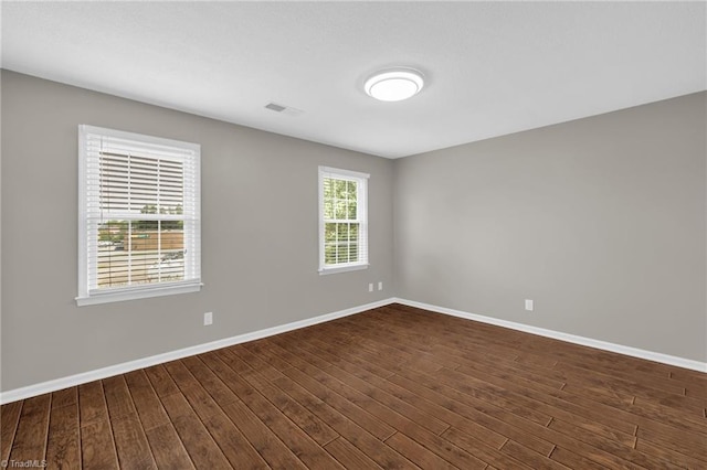 5660 W Market St Unit A, Greensboro, NC 27409 - spare room featuring dark wood-style flooring and baseboards