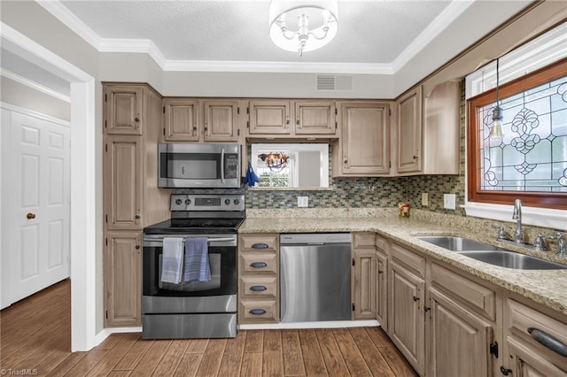 5660 W Market St Unit A, Greensboro, NC 27409 - kitchen featuring stainless steel appliances, a sink, wood finished floors, light stone countertops, and backsplash