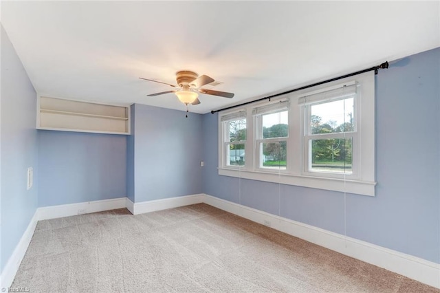 carpeted empty room featuring ceiling fan