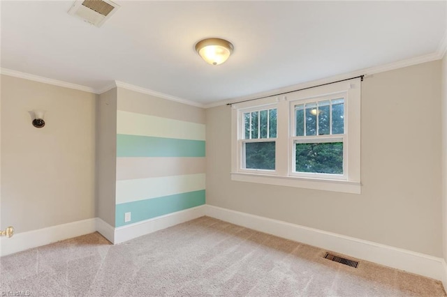 carpeted spare room featuring ornamental molding