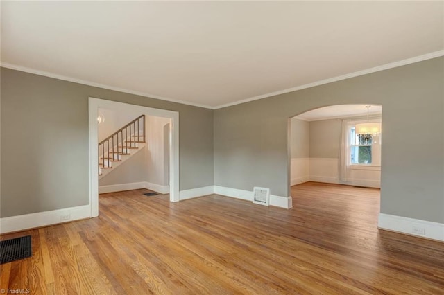 unfurnished room featuring wood-type flooring and ornamental molding