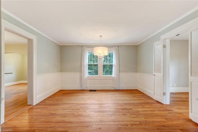 unfurnished dining area with light hardwood / wood-style flooring and crown molding