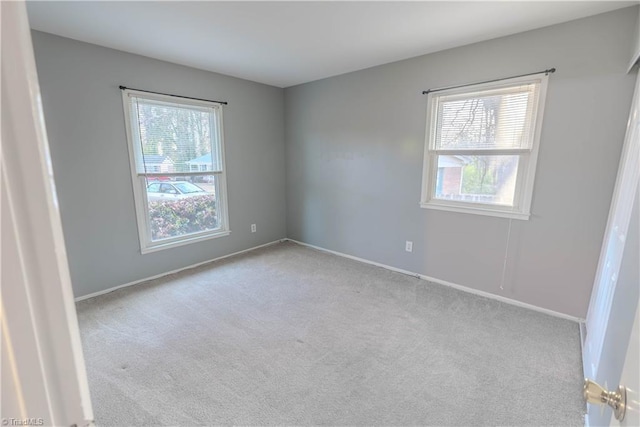 carpeted spare room with a wealth of natural light