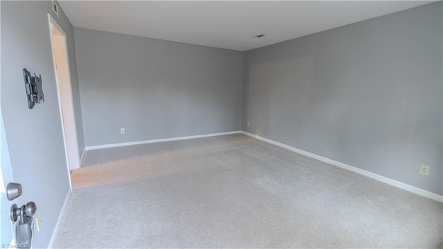 spare room with light colored carpet