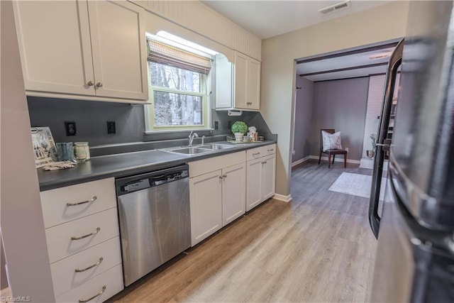 kitchen featuring white cabinetry, dishwasher, sink, and light hardwood / wood-style flooring