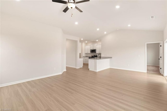 unfurnished living room featuring light hardwood / wood-style flooring, ceiling fan, lofted ceiling, and sink