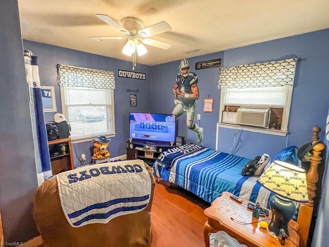 2778 Reynolds Park Rd, Winston-Salem, NC 27107 - bedroom with ceiling fan, cooling unit, and wood finished floors