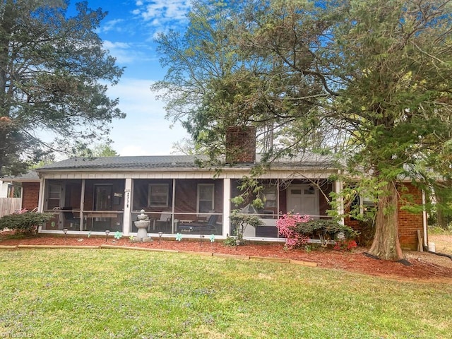 2778 Reynolds Park Rd, Winston-Salem, NC 27107 - rear view of property with brick siding, a chimney, a sunroom, and a lawn