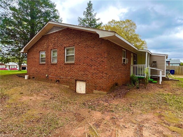 2778 Reynolds Park Rd, Winston-Salem, NC 27107 - view of property exterior with cooling unit, fence, crawl space, and brick siding