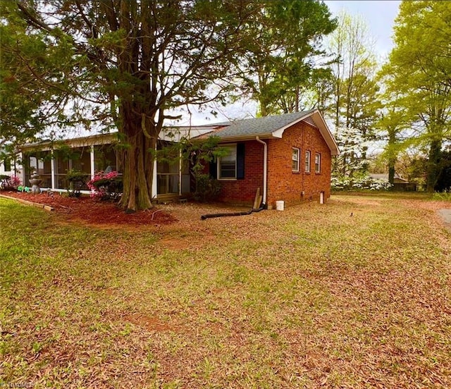2778 Reynolds Park Rd, Winston-Salem, NC 27107 - rear view of house featuring brick siding, a sunroom, and a lawn