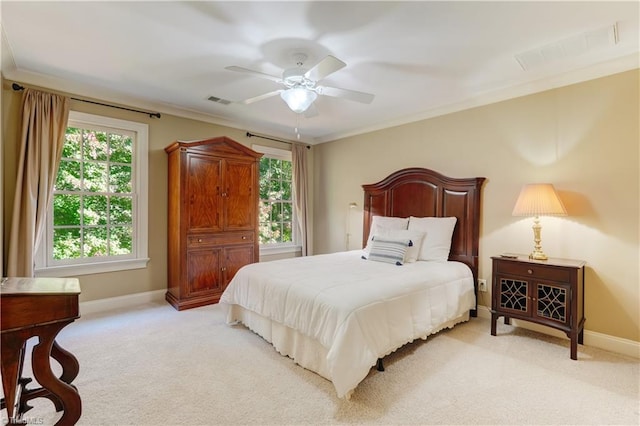 bedroom featuring crown molding, light colored carpet, and ceiling fan