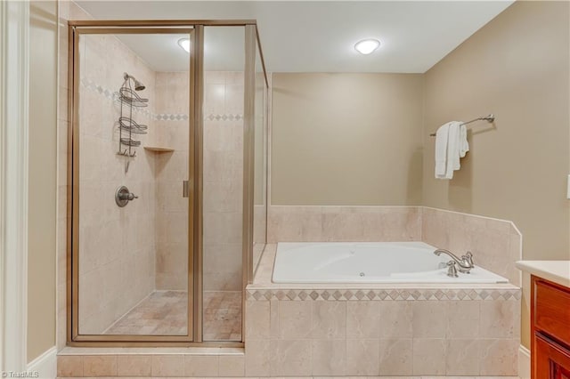 bathroom featuring vanity and shower with separate bathtub