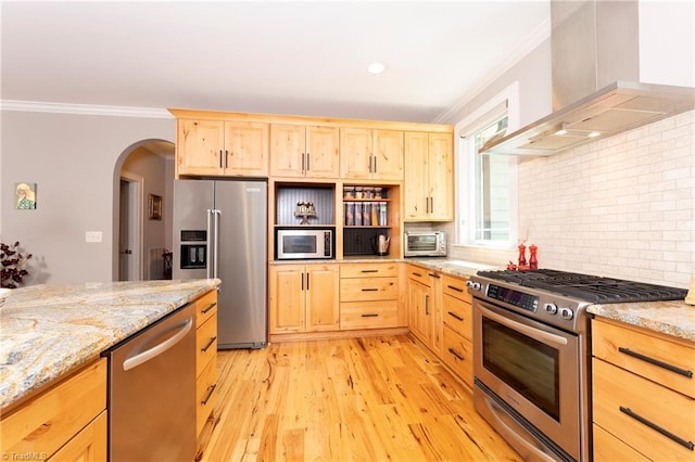 kitchen with wall chimney range hood, light hardwood / wood-style flooring, stainless steel appliances, ornamental molding, and light brown cabinetry