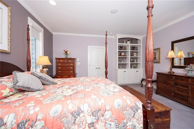 carpeted bedroom featuring crown molding and a closet