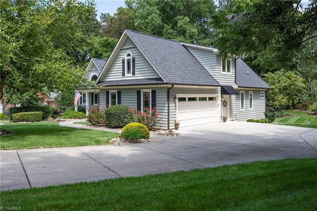 view of front of property featuring a garage and a front lawn