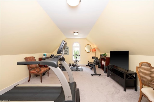 workout area featuring light colored carpet and lofted ceiling