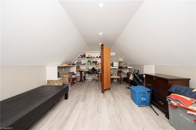 additional living space featuring lofted ceiling and light hardwood / wood-style floors