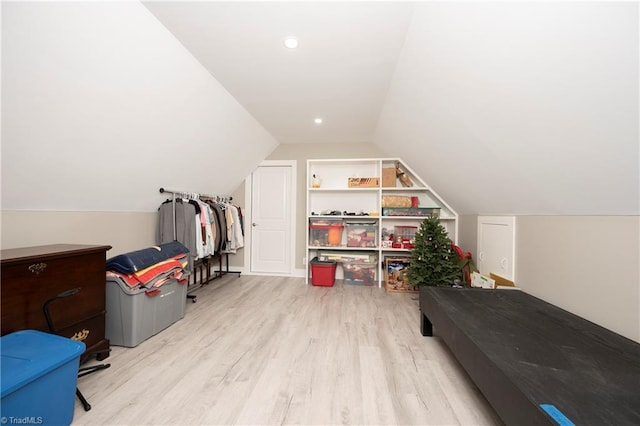 additional living space featuring light hardwood / wood-style flooring and vaulted ceiling