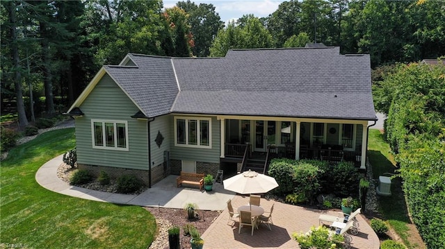 back of property featuring a yard and a patio area