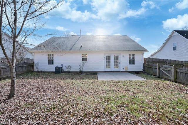 rear view of property with french doors, a patio, and central AC