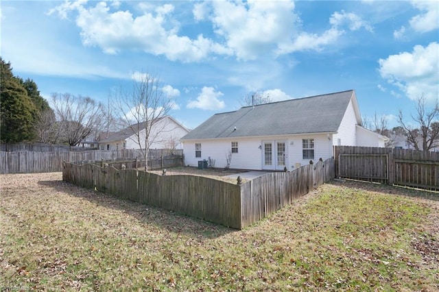 back of house featuring a yard, central AC unit, and french doors