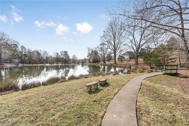 surrounding community featuring a yard and a water view