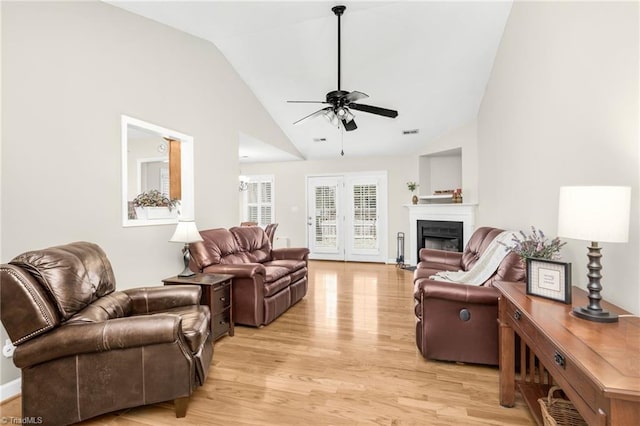 living room with ceiling fan, high vaulted ceiling, and light hardwood / wood-style floors