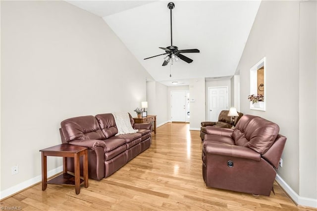 living room with ceiling fan, light hardwood / wood-style flooring, and high vaulted ceiling