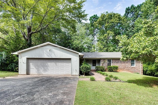 single story home with a garage and a front lawn