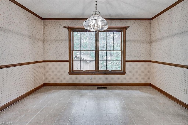 spare room with a notable chandelier and ornamental molding