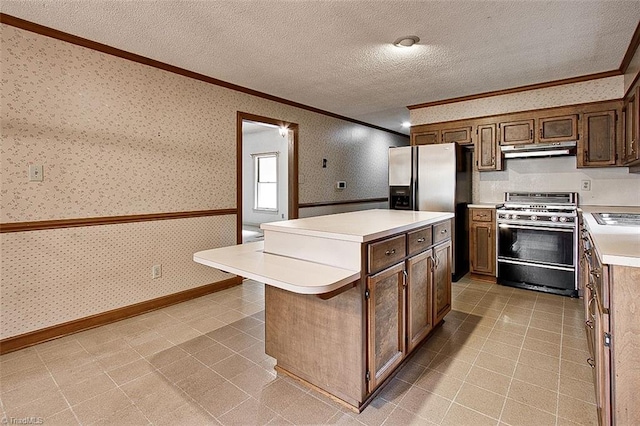 kitchen with a textured ceiling, a center island, gas range, and stainless steel fridge