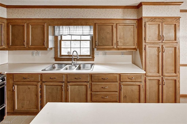 kitchen featuring ornamental molding and sink