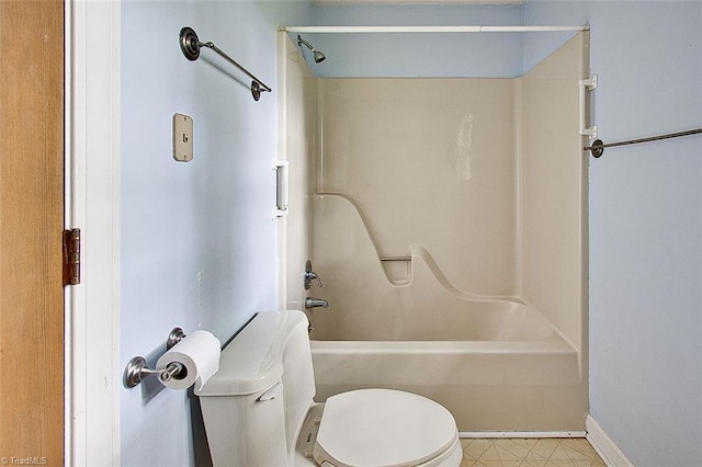 bathroom with bathing tub / shower combination and toilet